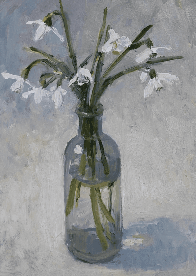 Snow drops in a glass bottle